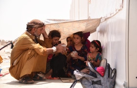 Family shelters under a sheet