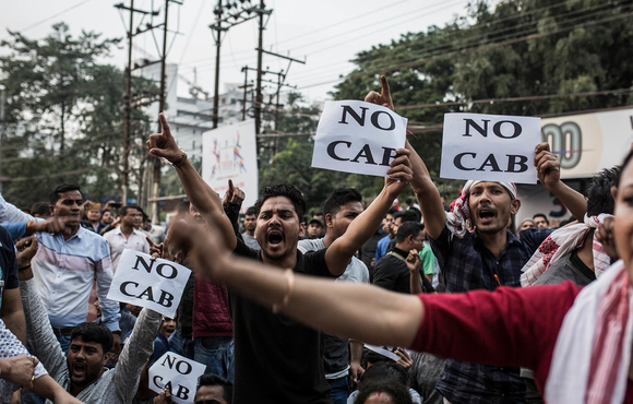 Protesters hold signs denouncing changes to India’s citizenship laws during a demonstration in Guwahati.
