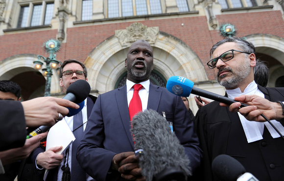 The Gambia's justice minister, Abubacarr Tambadou, talks to the media outside the International Court of Justice.