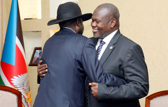 South Sudan's President Salva Kiir embraces Riek Machar, now vice president again, during a meeting at the State House in Juba on 15 January 2020.