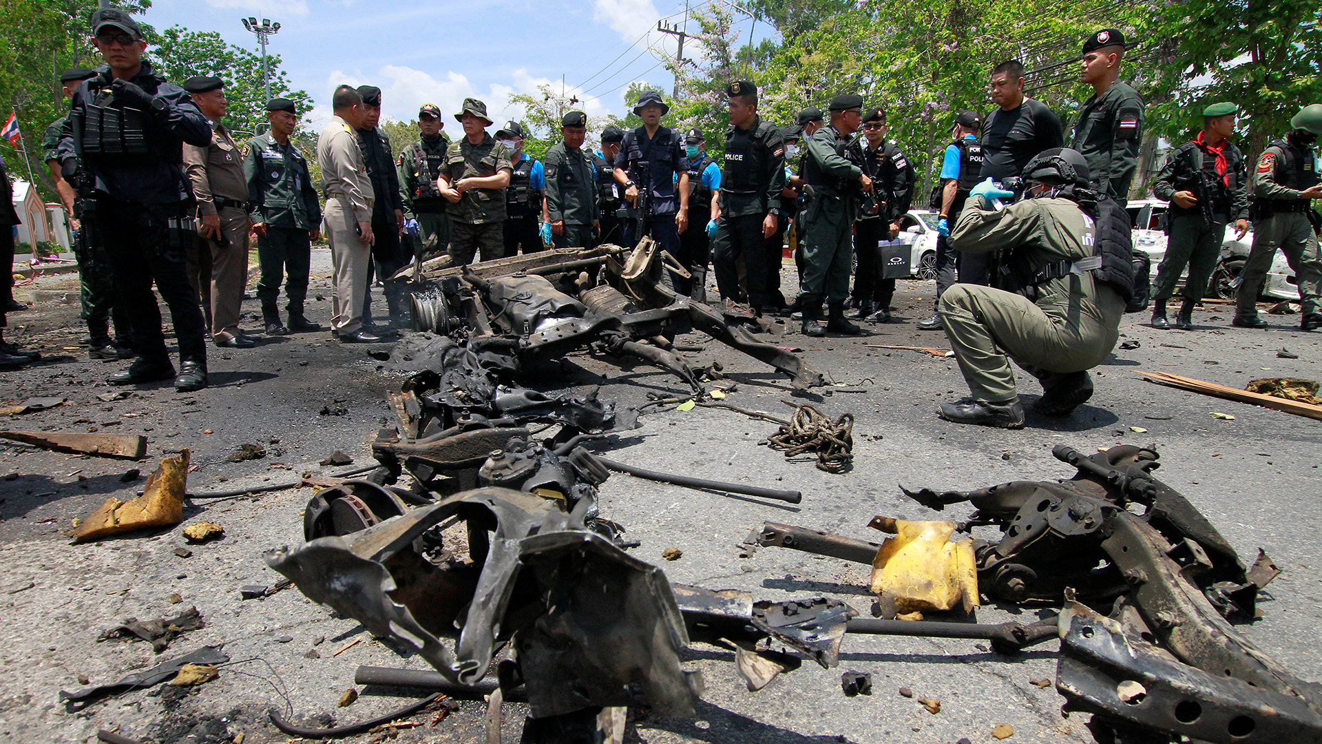 Security personnel inspect the site of a car bomb in Yala, Thailand