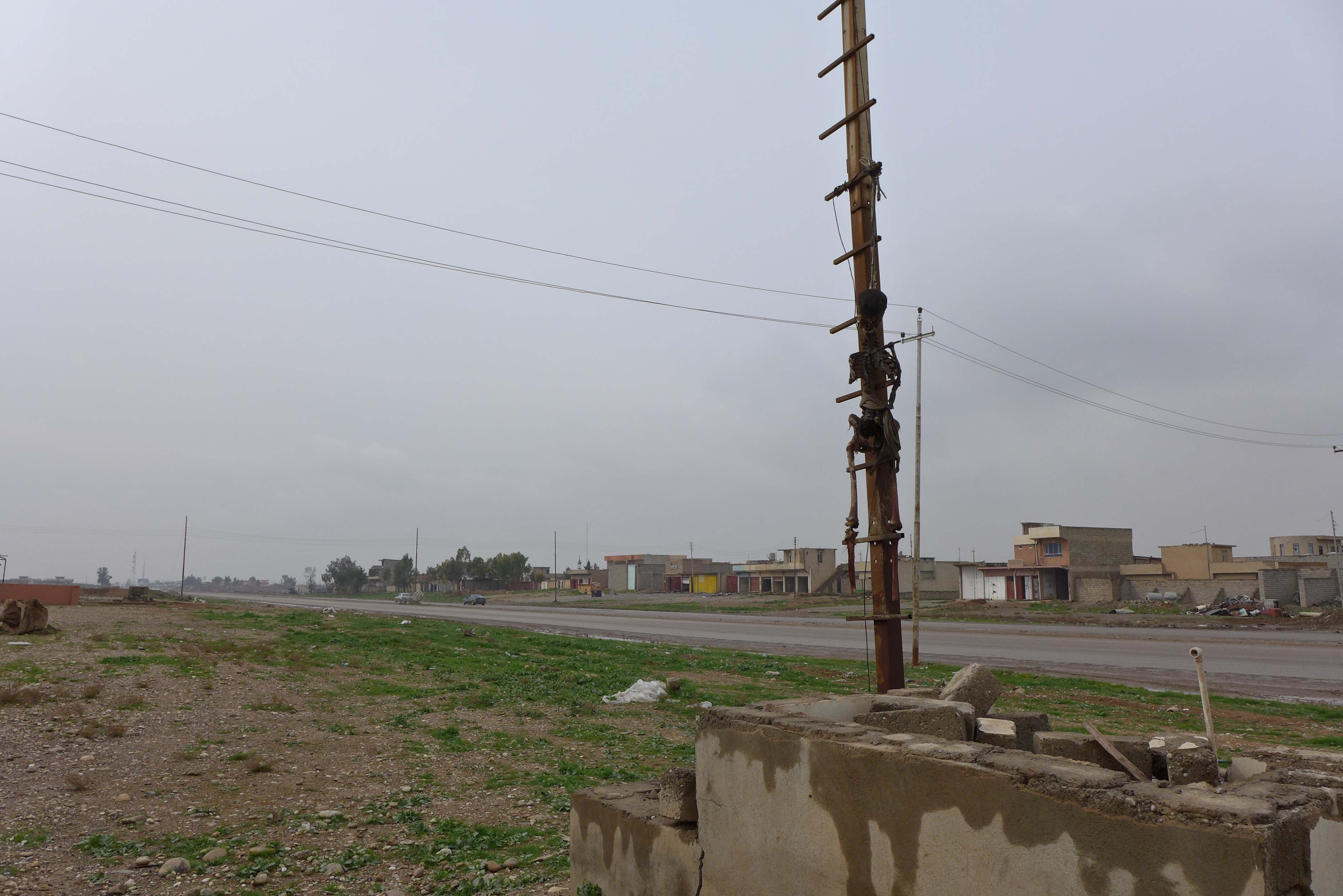 Skeleton hanging on an electricity pole