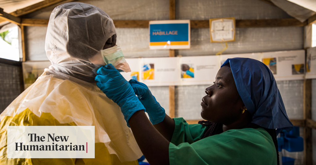 A health worker puts on protective scrubs before entering an Ebola treatment centre in Beni, Democratic Republic of Congo.