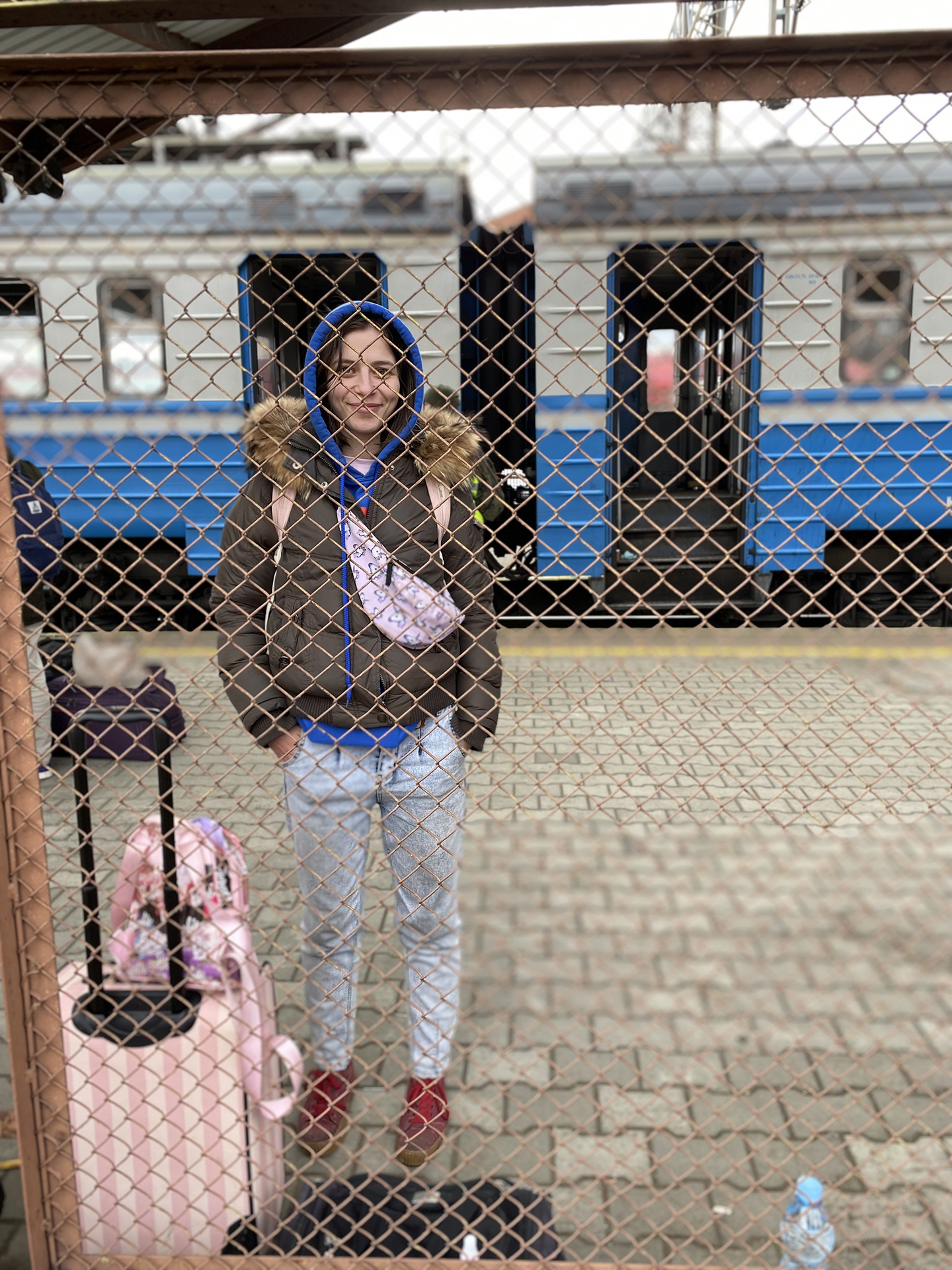 Anna Kozhuhkarova, a jewellery designer, escaped Kyiv by train and waits by passport control to enter Poland.
