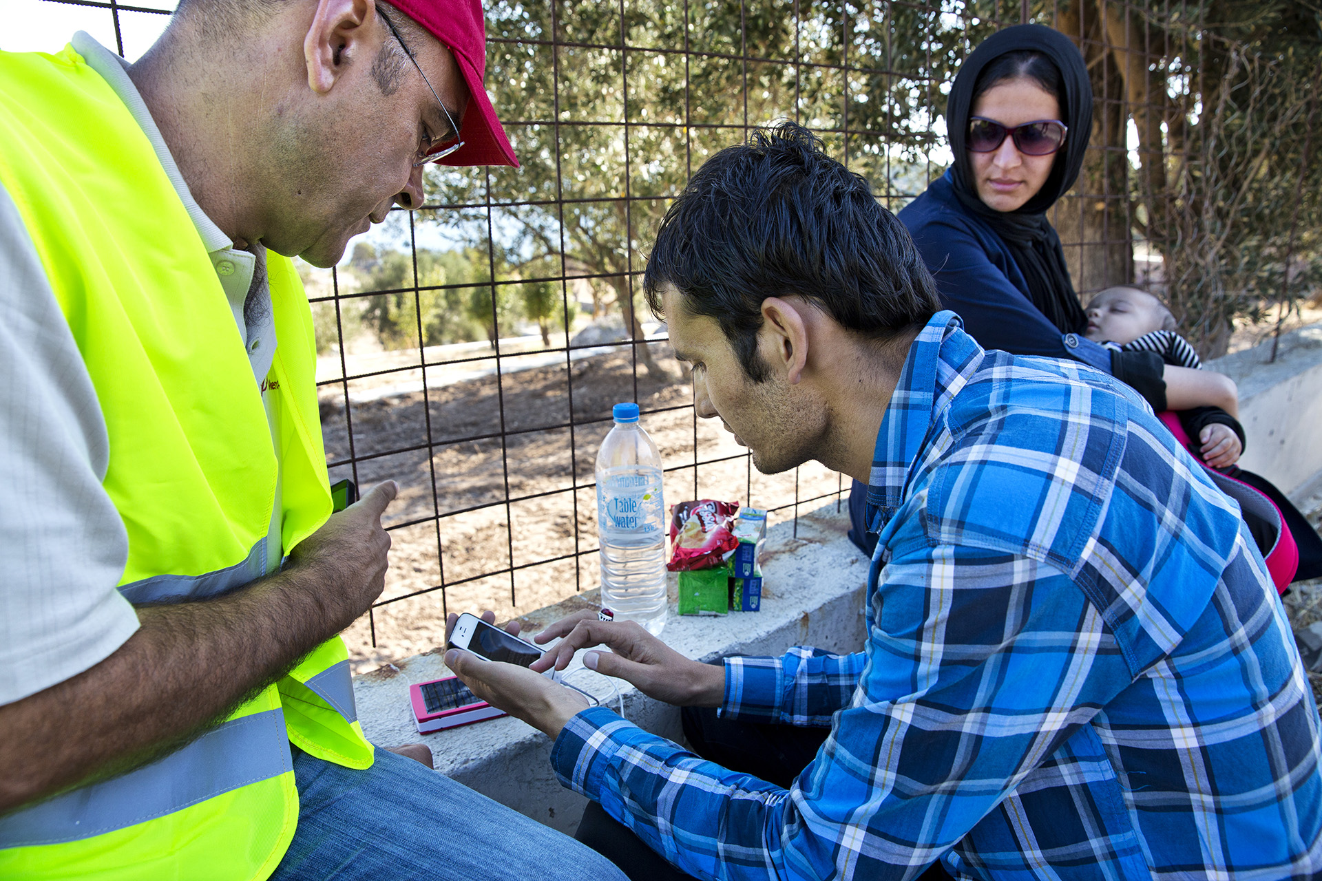 Image of Mugur Dumitrache helping a family from Afghanistan