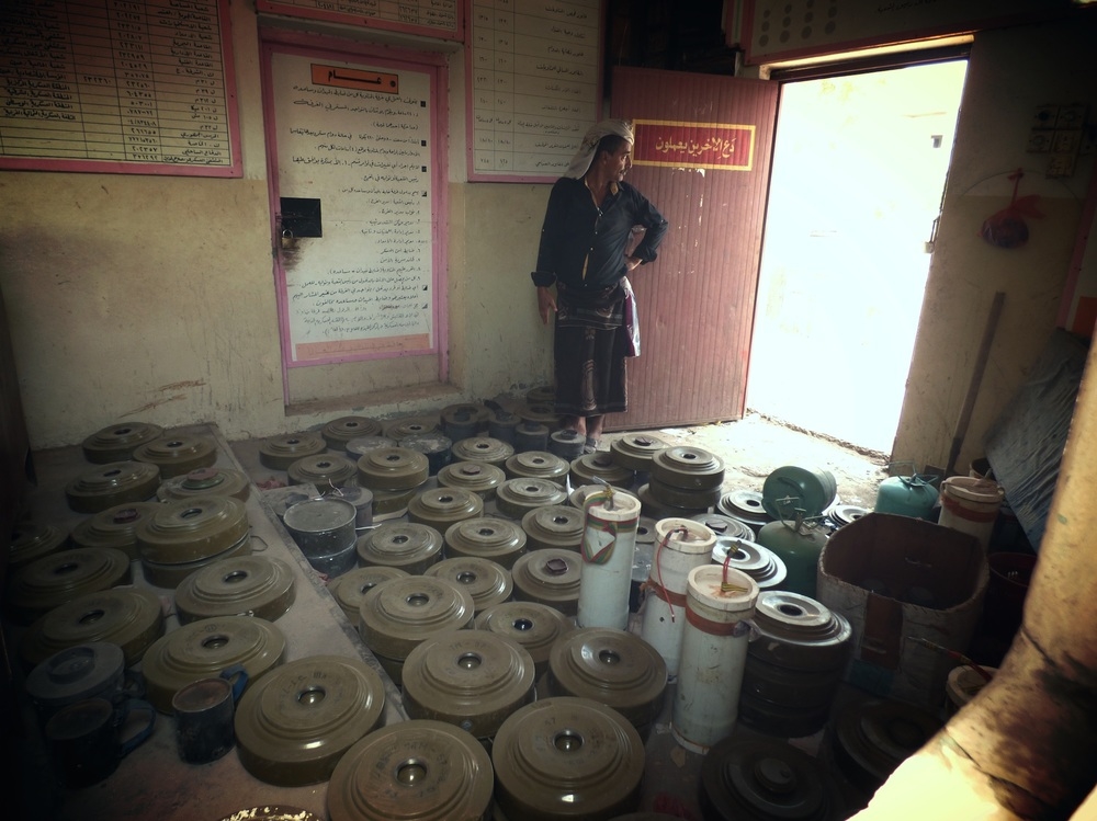 A person in Aden, Yemen stands in a room full of mines.