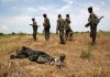 Victorious SPLA soldiers and dead rebel