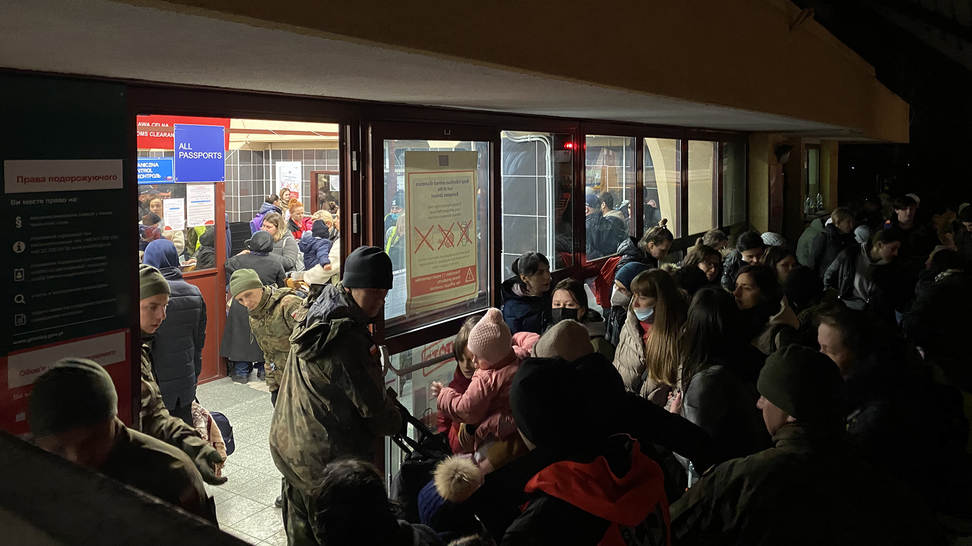 Crowds of refugees from Ukraine wait outside passport control at Przemyśl train station.