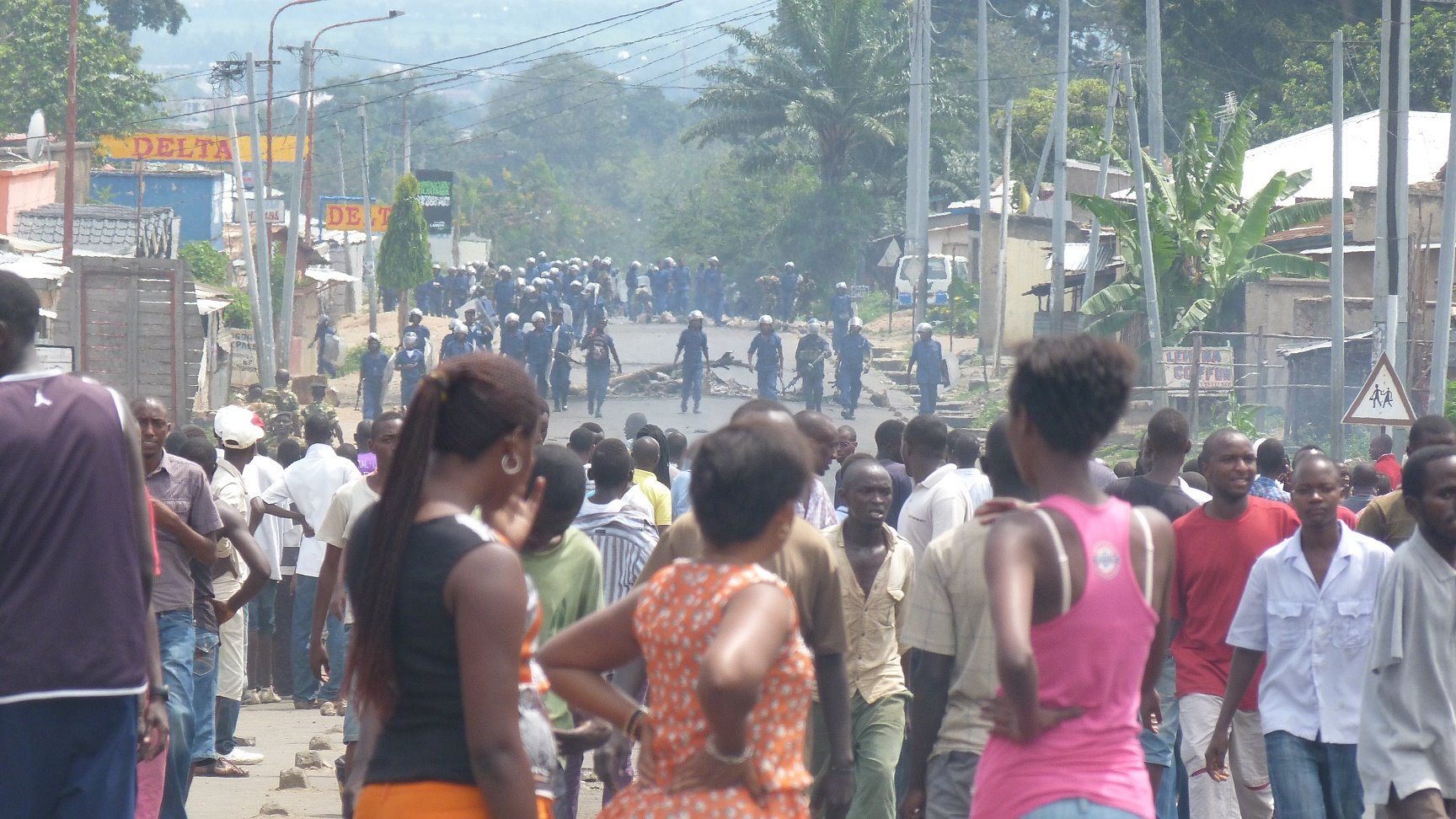 Who are the Imbonerakure and is Burundi unravelling?* Police look on as people demonstrate in Bujumbura against a decision by Burundi's ruling party to nominate President Pierre Nkurunziza to run for a third term in elections slated for June 2015.