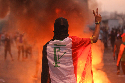 An Iraqi protester gestures the v-sign during a demonstration in Baghdad on 2 October 2019.