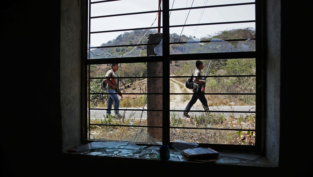 Community police patrol the streets before a demonstration against narco-violence in the town of Alcozacán in Guerrero state in April 2021. The Mexican government is reluctant to admit gang violence is driving displacement. 