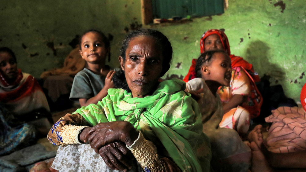 A woman sits with her family at a camp for internally displaced people in Ethiopia’s Amhara region, on 8 October.