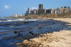 [Lebanon] The popular public beach of Ramlet el-Baida covered with heavy fuel oil, Beirut, 29 July 2006. Much of Lebanon’s coastline is affected after oil spilled into the sea when storage tanks at a power plant in Jiyeh, 30km south of Beirut, were hit 
