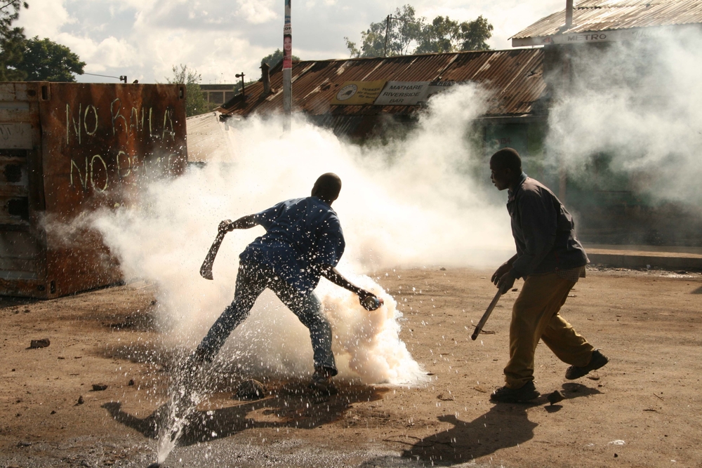 Demonstrators throw back tear gas to the police, Mathare slums, Nairobi