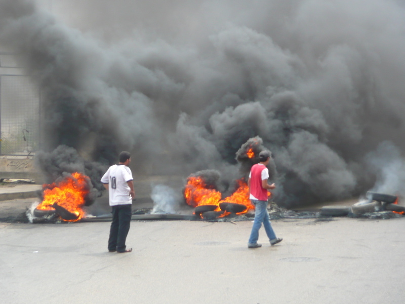 Supporters of the Hezbollah-led opposition burn tyres to pressure the western-backed government.