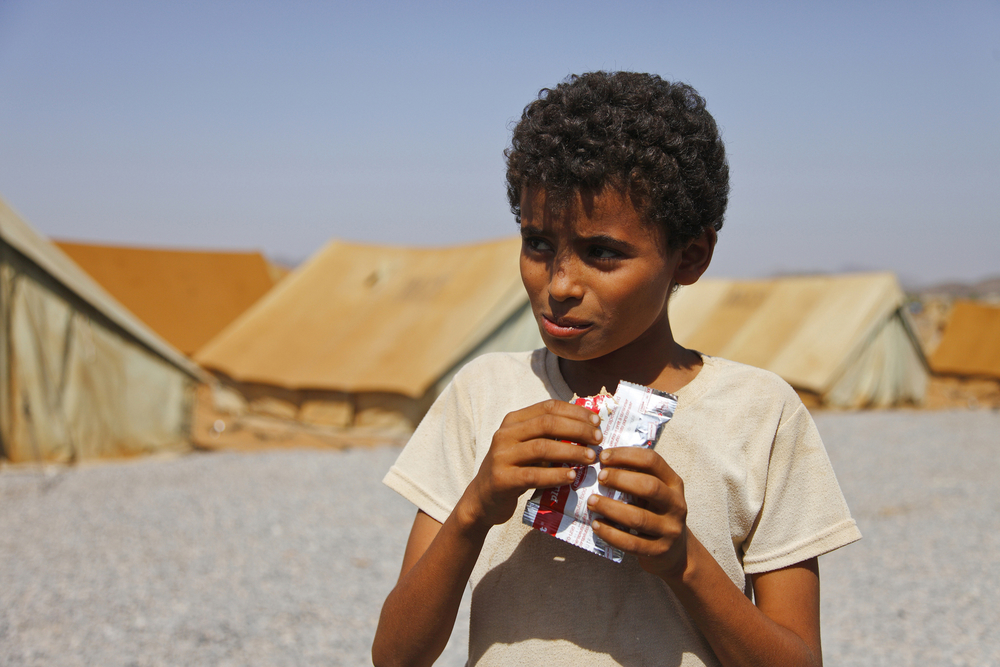 A boy in Mazrak IDP camp in north-west Yemen eats Plumpy’nut, a peanut-based food used in famine relief 