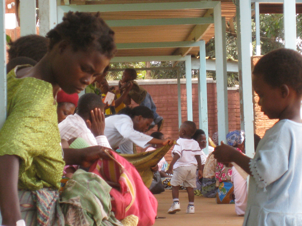 A mother and her child wait to see a nurse at Kawale Clinic in Lilongwe, Malawi