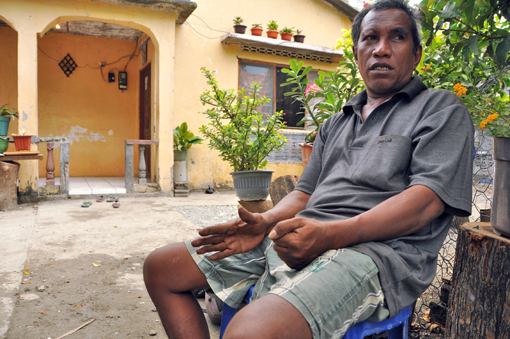 Pedro Damaeao, in front of his home in Manatutu, East Timor, says he wants justice for his father who was detained and tortured by Indonesian soldiers. As many as 180,000 people in Timor Leste were killed during the Indonesian occupation from 1975 to 1999