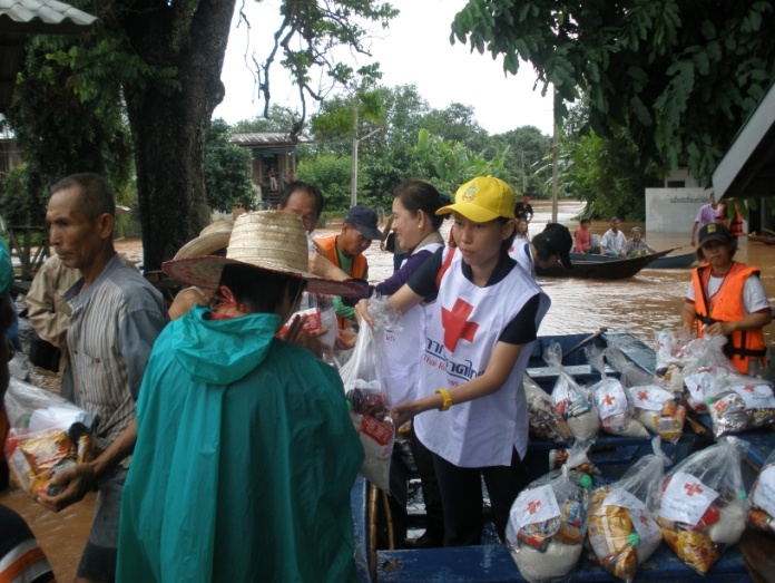 An aid worker for the Thai Red Cross distributes relief assistance. Heavy monsoons rains have affected hundreds of thousands of residents across Thailand