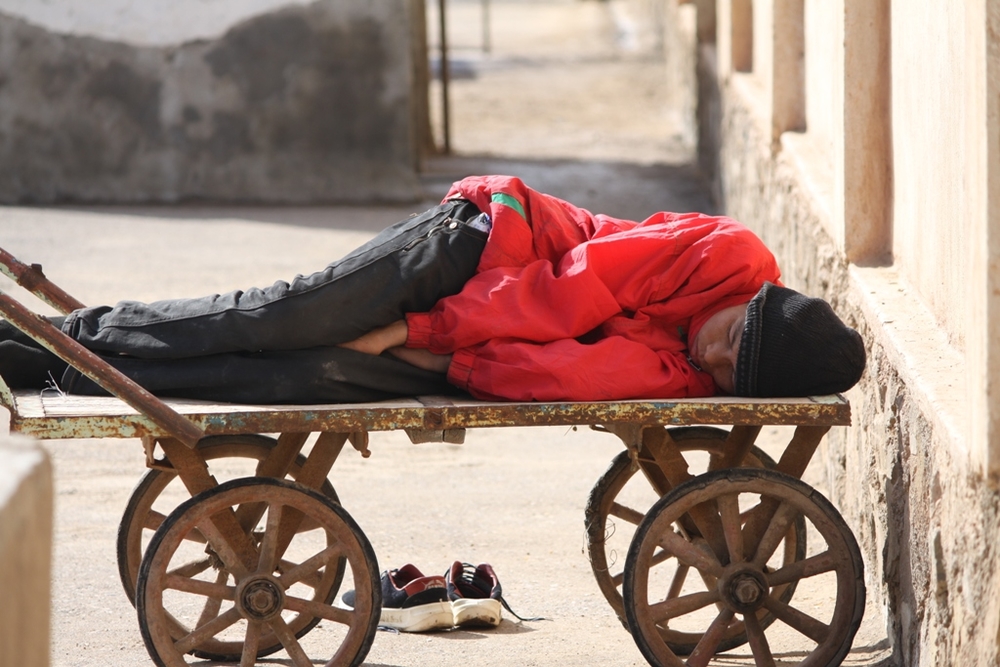 Jawad, 15, sleeps on a cart in a transit centre in Islam Qala, on the Afghan-Iranian border. He was separated from his guardian, his elder brother, and deported back to Afghanistan by Iranian officials
