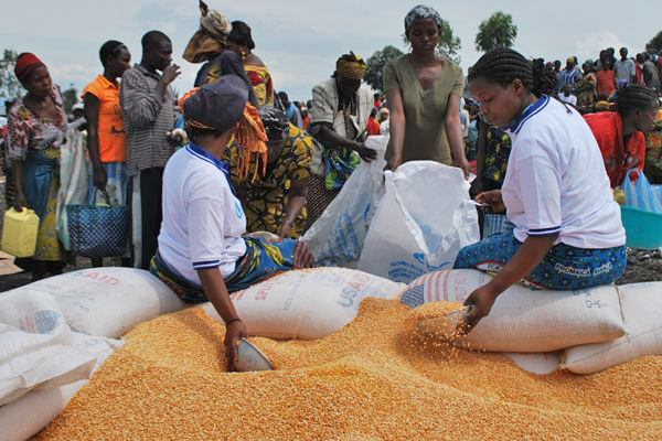 Aid workers fill bags of fortified cereal for new arrivals to the Mugunga camp in eastern DR Congo