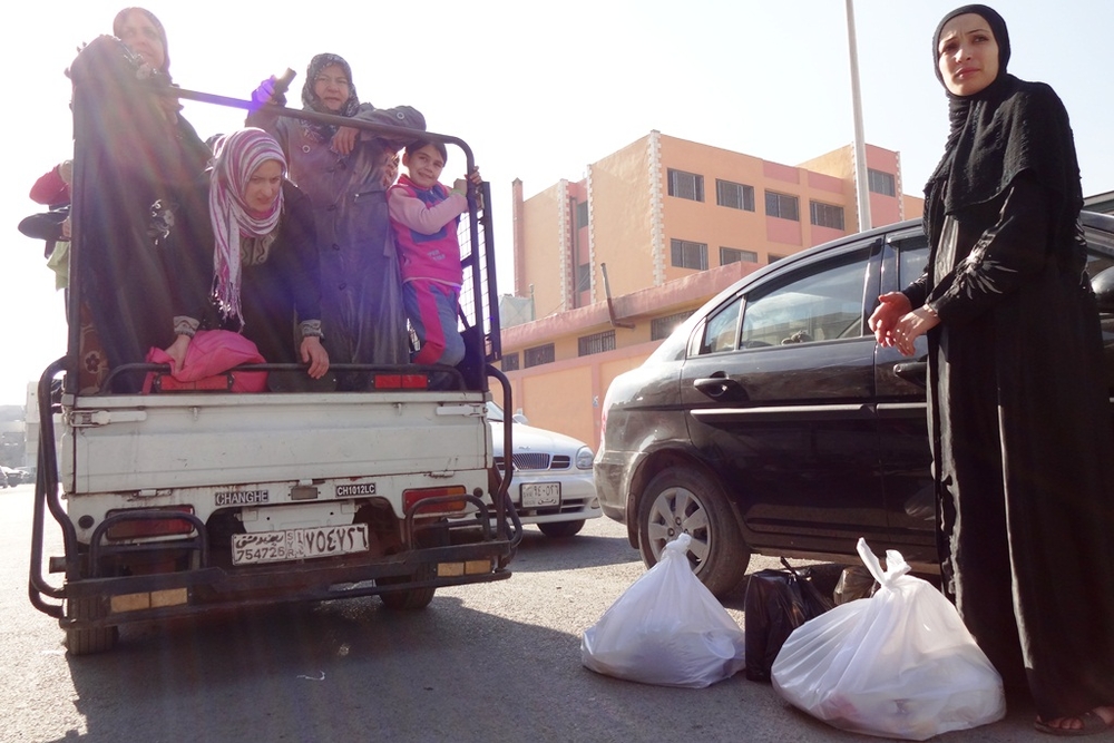 Nowhere to run Syrians displaced from Homs, Hama and Rural Damascus, and now living in the capital's suburbs, pack into a mini-truck to come into the city to pick up food aid, mattresses and other supplies from an aid organization