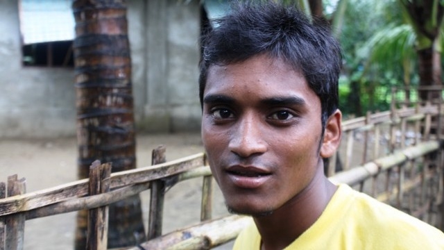 A young Rohingya boy looks to the camera at the Thea Chaung IDP camp outside Sittwe, More than one year after sectarian violence left more than 140,000 people displaced, little has been done to address the needs of adolescents and youth