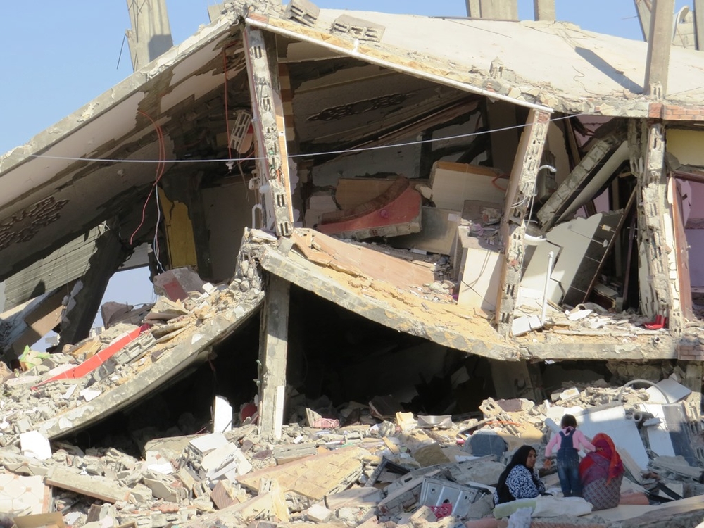 Women and a child sit in the shade amid the rubble of a home in Rafah town in Egypt's North Sinai governorate. The building was destroyed in October during the security forces' counter-terrorism campaign against militants. (Photo taken by Sophie Anmuth in