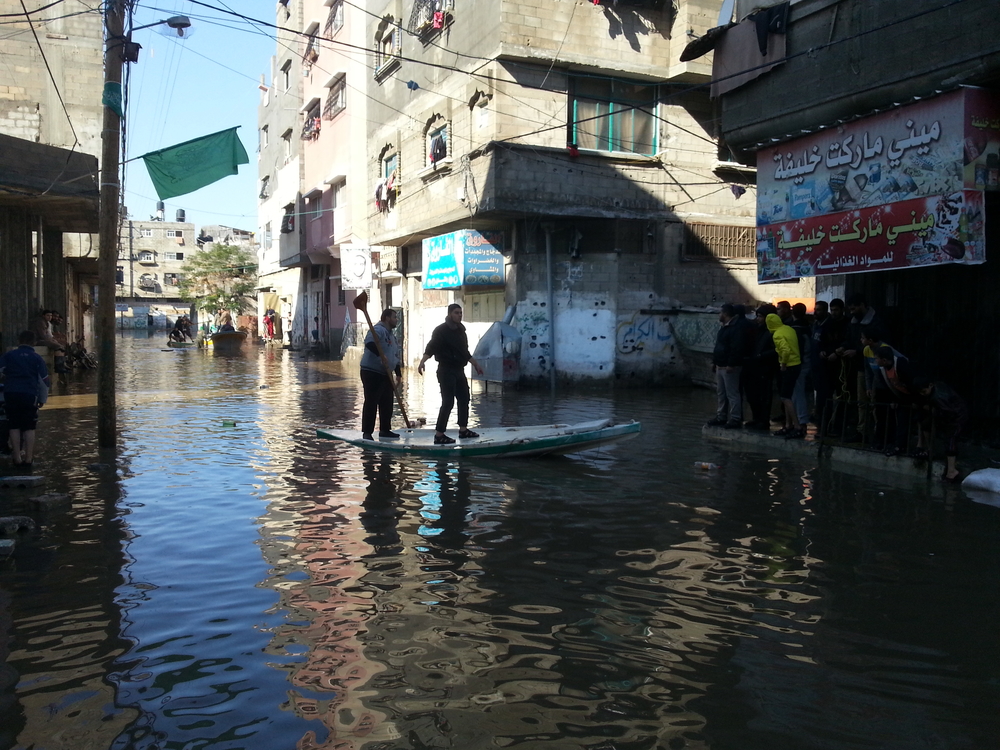 Crews use boats to rescue people stranded by flood waters in Gaza City's Zeitoun area after heavy rains from 11-15 December 2013. (Photo taken on 15 December)