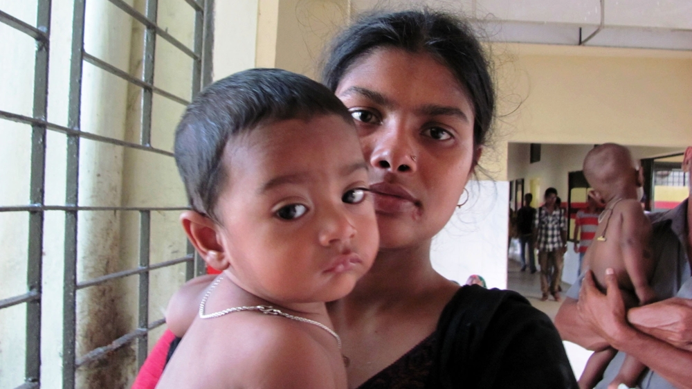 A mother and child a a hospital in Bangladesh for a check-up. She says she received voice messages daily during pregnancy and after she gave birth, which helped her raise her child.