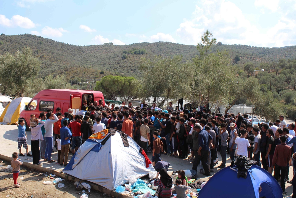 Non syrian refugees jostle for food at a volunteer distribution in Moria camp, Lesbos. Many have spent all their money getting to Greece and have no cash even for basics such as food.