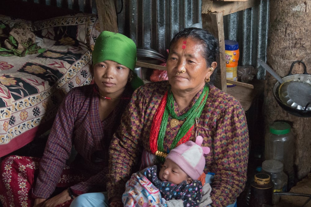 Politics prevents Nepal reconstruction Bimala Thami sits with community health worker Gauri Thami in October 2015 in the temporary shelter she lives in with her infant in Nepal's Dolakha district after her house was destroyed by a earthquake on 25 April 2015