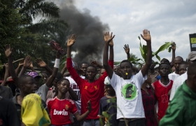 Protestors raise their hands in front of police in the Musaga neighbourhood of Bujumbura, Burundi, on May 4, 2015.