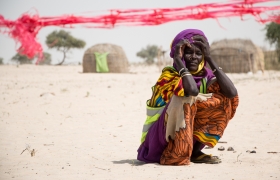 Displaced families gather for another distribution of cash handouts