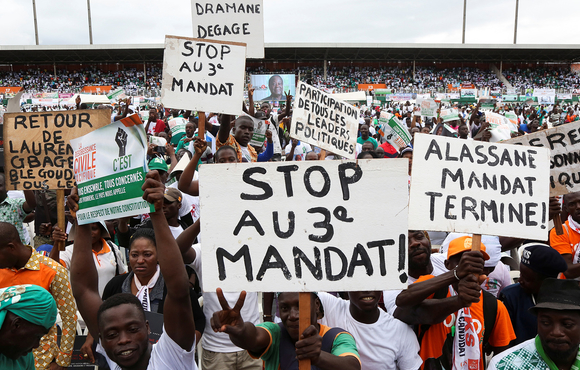 Supporters of Côte d'Ivoire’s opposition coalition parties hold signs during a stadium rally to protest against president Alassane Ouattara's bid for a third term in Abidjan, Côte d'Ivoire, 10 October, 2020. The front sign reads: "Stop to a third term".