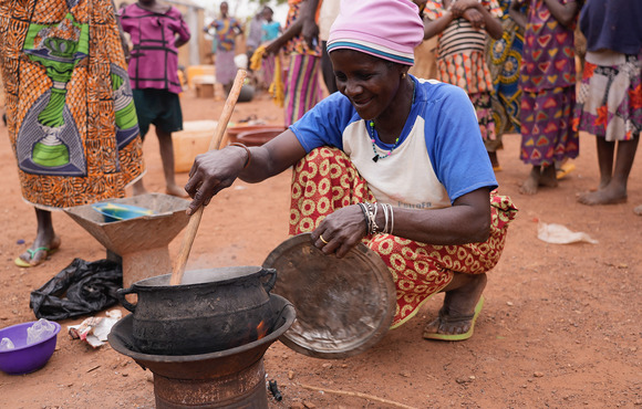  A woman cooks food at a displacement camp in the northern town of Ouahigouya. Nearly two million people have been uprooted in the country. 