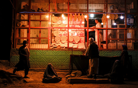 People wait in front of a bakery in Kabul, Afghanistan, on 4 October 2021. 