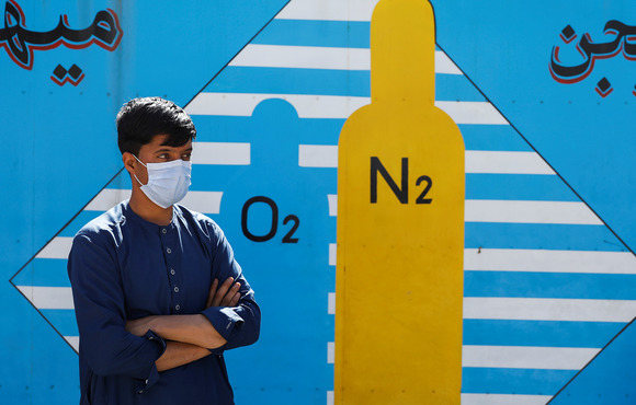 A man waits outside a factory to get his oxygen cylinder refilled, amidst the spread of the coronavirus disease in Kabul, Afghanistan 15 June 2021. 