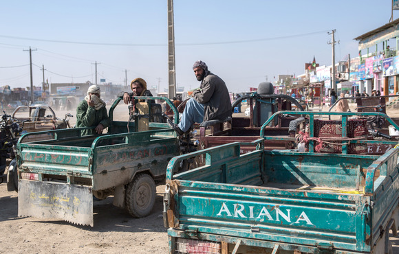 Drivers wait to take people on a route leading back to Iran in Zaranj, a border town in southwestern Afghanistan in January 2020. Nearly 860,000 Afghans returned from Iran in 2020. 