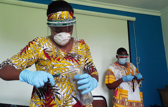 Making COVID-19 face shields from recycled plastics at a workshop in Dar es Salaam, Tanzania, 2020.