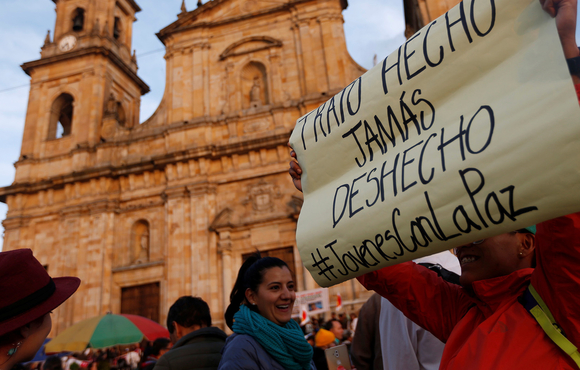 A woman holds a sign that reads, "Deal done, never undone", during a protest in support of the transitional justice body in Bogotá, Colombia, 13 March, 2019