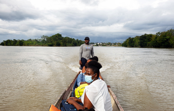 Even accessing victims to offer them support can be hard in remote, violence-prone areas. Here, women's leader Rosa Lozano rides on a wooden boat along the Rio Atrato on her way to help GBV survivors in Colombia's lawless Chocó region.