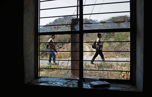 Community police patrol the streets before a demonstration against narco-violence in the town of Alcozacán in Guerrero state in April 2021. The Mexican government is reluctant to admit gang violence is driving displacement. 