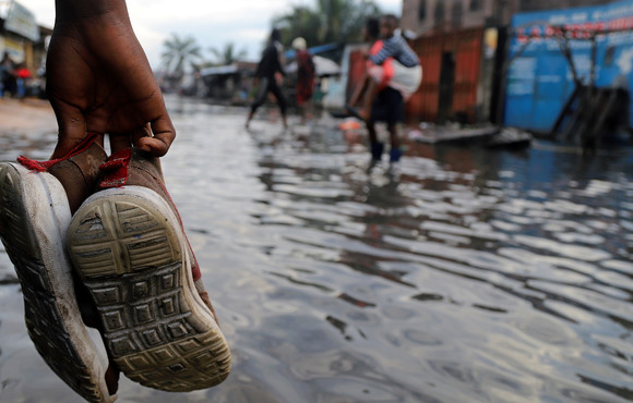 A Congolese man wades through floodwaters after the Congo River’s banks burst due to heavy rainfall in Kinshasa, Democratic Republic of Congo 9 January, 2020.