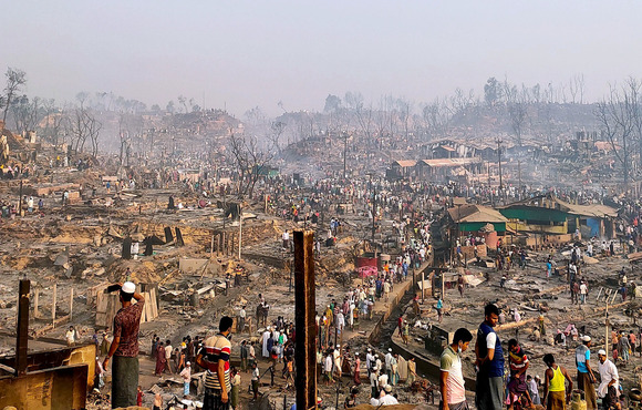 A smokey view of a part of the Cox Bazar refugee camp damaged by a large fire.