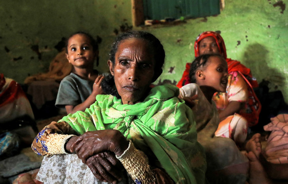 A woman sits with her family at a camp for internally displaced people in Ethiopia’s Amhara region, on 8 October.