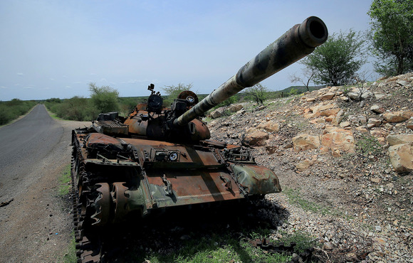 A tank damaged during fighting between the Ethiopian military and Tigrayan rebels lies abandoned on the outskirts of Humera town in July 2021.