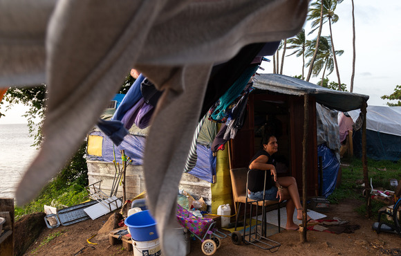 Cuban asylum seeker Yuneisy Velázquez sits in front of her makeshift tent in Cayenne. 