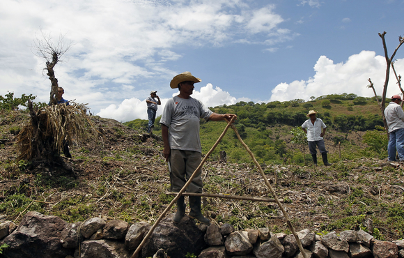 Farmers wait during a distribution of food aid to families affected by the drought in the village of Orocuina, Honduras