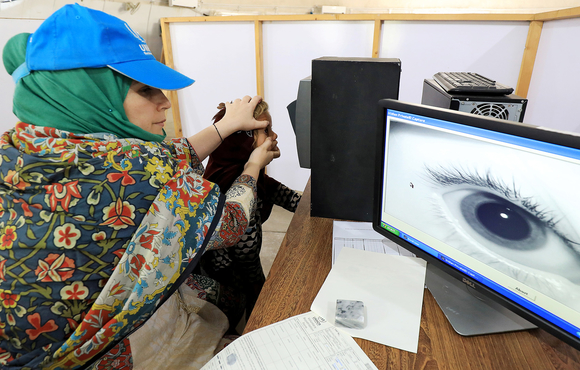 An Afghan refugee has her iris scanned by the UN Refugee Agency in Pakistan, June 2019